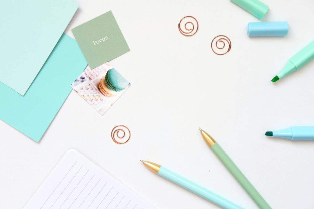 Navigating ADHD in Adults: Practical Strategies and Support Near Waterford, Michigan 2 Minimalist desk with teal stationery and focus note, ideal for productivity and mindfulness.