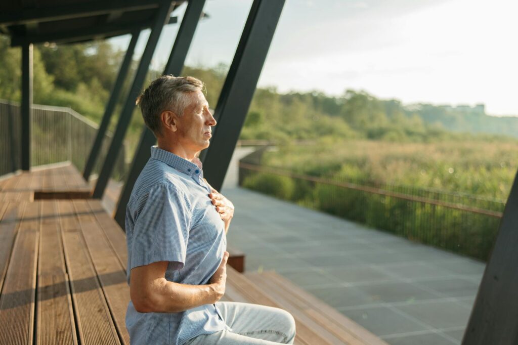 Managing Social Anxiety in Waterford, Michigan: Practical Strategies and Local Resources 2 Senior man practicing meditation outdoors, embracing peaceful relaxation and mindfulness during daylight hours.