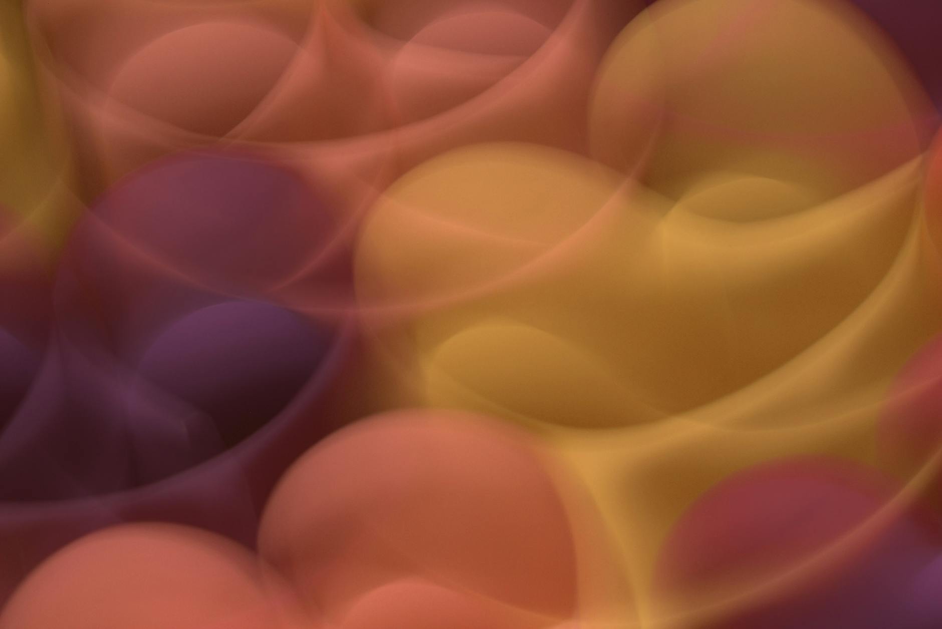 Colorful abstract pattern using warm orange, yellow, and purple hues with smooth gradients.