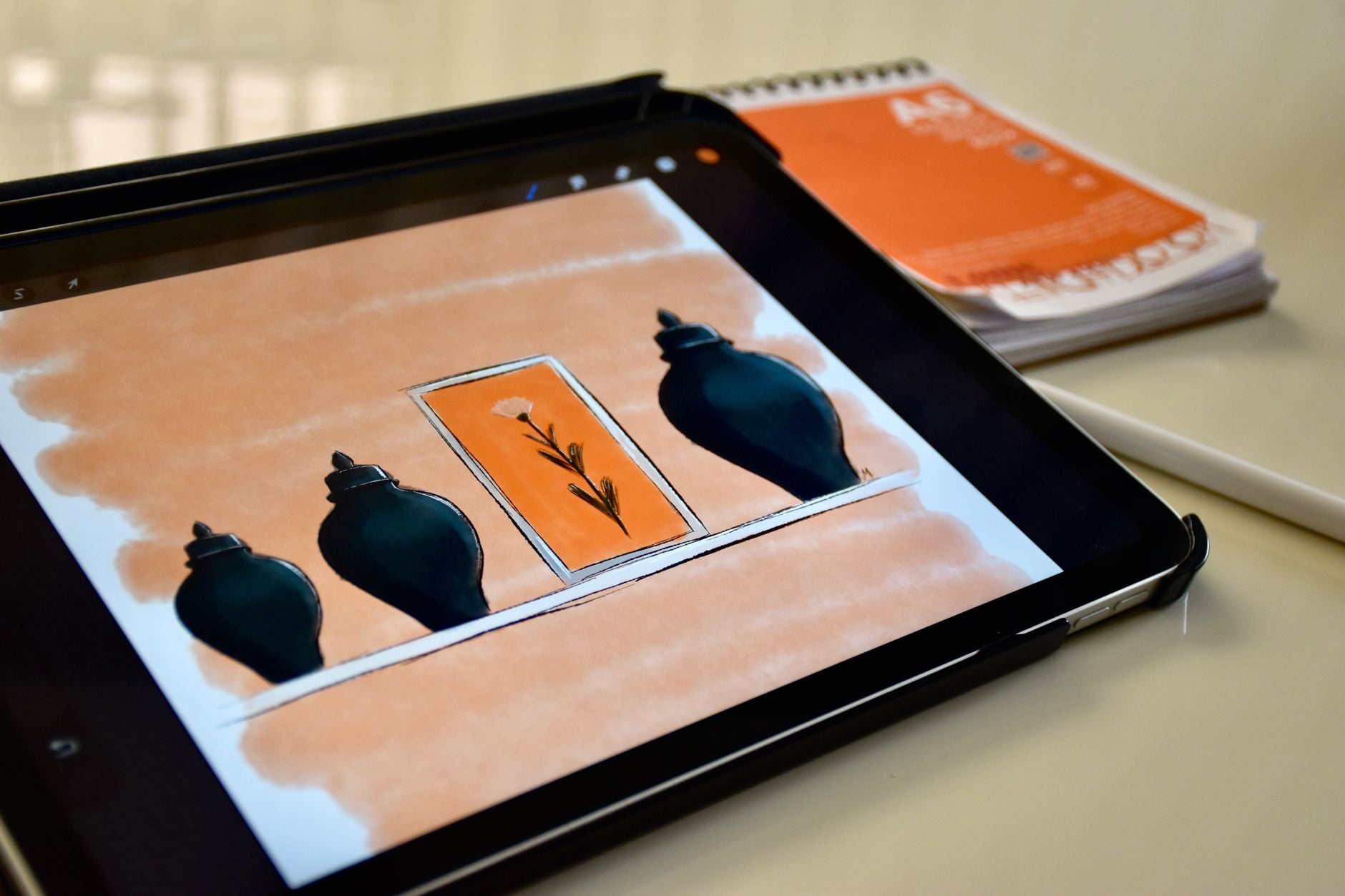 Blog 1 A digital sketch of vases and a flower displayed on a tablet with a stylus and notebook nearby.
