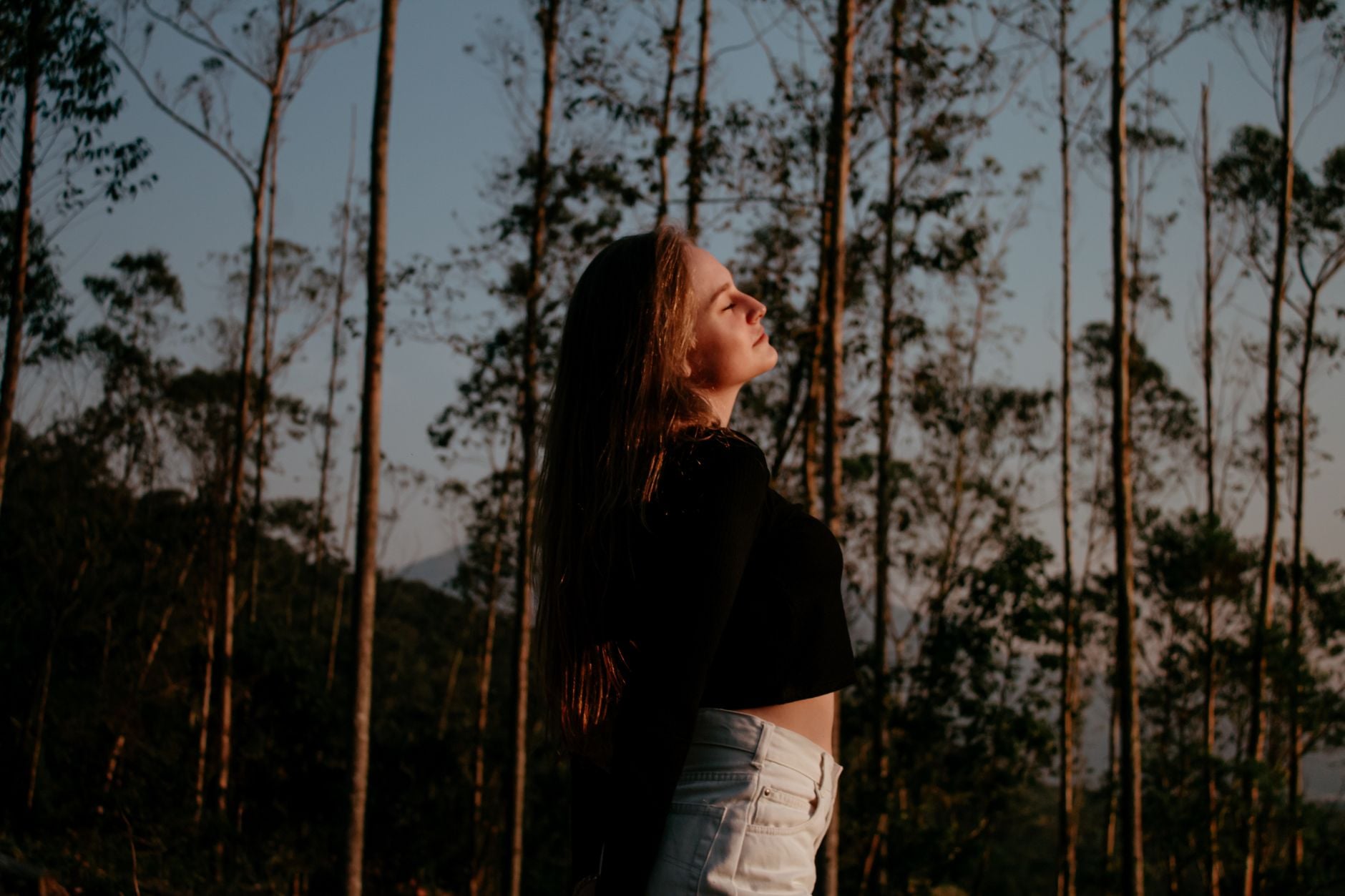 Blog 6 Portrait of a woman enjoying nature and freedom in a forest setting.