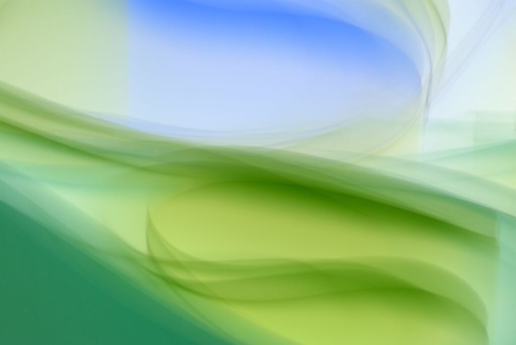 How Can I Manage Mental Health-Related Perfectionism to Reduce Stress and Improve Well-Being? 2 Abstract image featuring smooth green and blue waves creating a fluid, calming background.